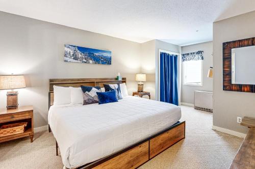 a large bedroom with a large bed and a tv at Vantage Point #8 in Stratton