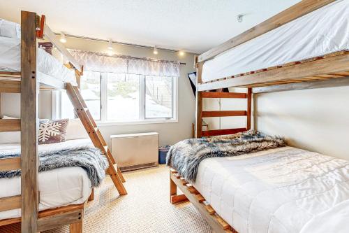 a bedroom with two bunk beds and a window at Vantage Point #8 in Stratton