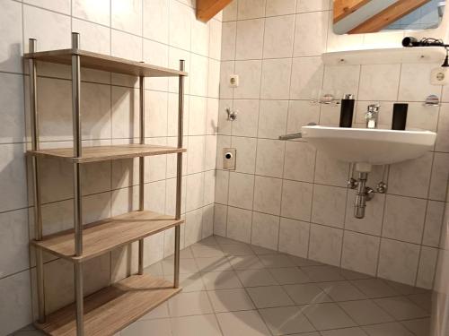 La salle de bains est pourvue d'un lavabo et d'un lavabo blanc. dans l'établissement Charmante, ruhige Wohnung in Innsbruck, à Innsbruck