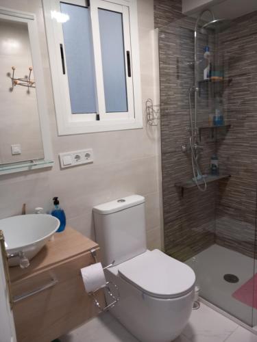 a bathroom with a toilet and a sink and a shower at Castellón in Castellón de la Plana
