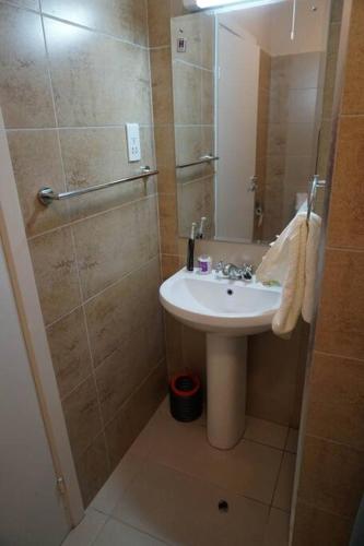 a bathroom with a sink and a shower at Modern 2BR Sanctuary, Pool & Gym in Nairobi