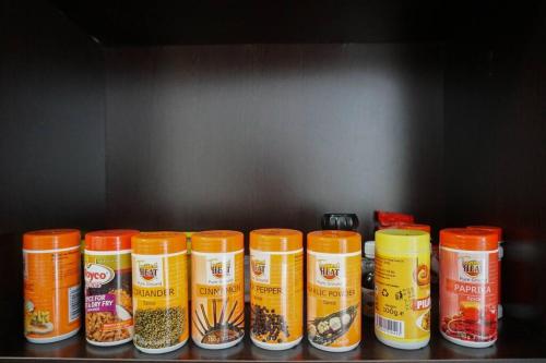 a row of containers of food sitting on a shelf at Modern 2BR Sanctuary, Pool & Gym in Nairobi
