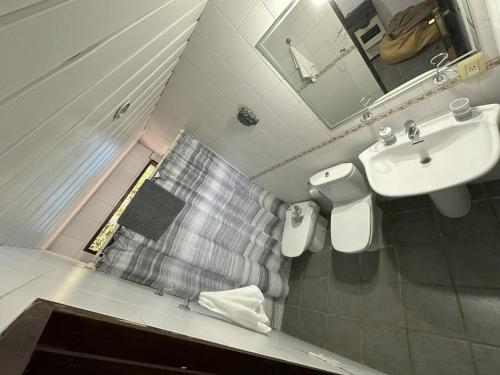 a bathroom with a sink and a toilet and a mirror at Ruca Luma B&B - Chacras in Ciudad Lujan de Cuyo