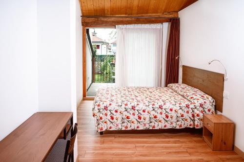 a bedroom with a bed and a window at La Casa del Ciliegio in Feltre