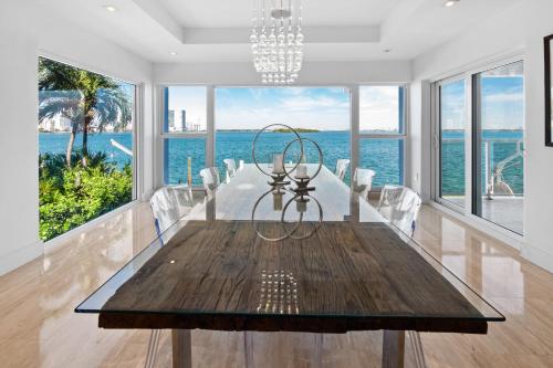 a dining room with a table and views of the ocean at Villa Milli in Miami