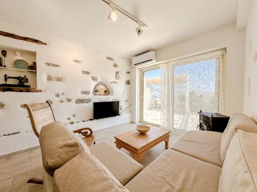 a living room with a couch and a tv at Mountain Bliss Guesthouse 2 next to Sougia in Agrilés