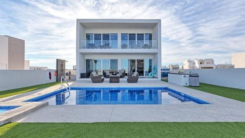 a house with a swimming pool on a roof at Luxury Retreat Playa Laguna: 5-Bedroom Bliss in Puerto Peñasco
