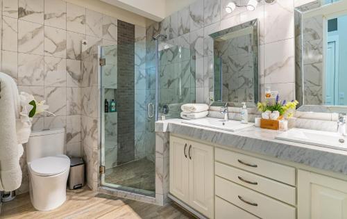 a bathroom with a shower and a sink at Palacio Blanco Luxury Villa 1 in La Ventana