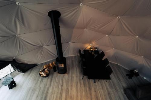a room with a large tent with a table in it at Golden Circle Domes - Lake View in Selfoss
