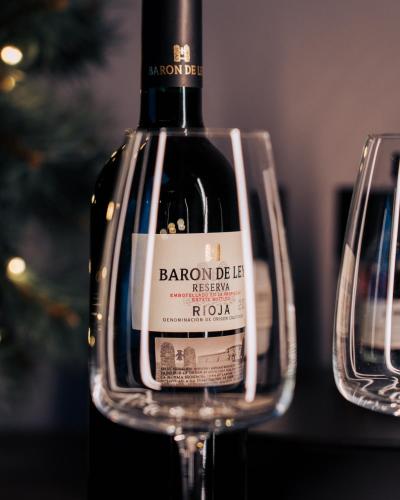 a bottle of wine sitting in two wine glasses at Golden Circle Domes - Lake View in Selfoss