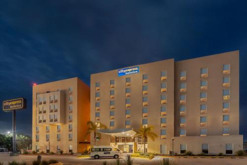 a hotel with a car parked in front of it at City Express by Marriott Celaya Galerias in Celaya