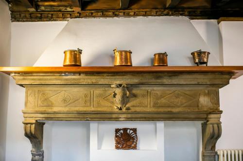 a wooden shelf with four tea cups on it at Casa di Bruno in Pellio Superiore