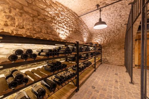a room filled with shelves filled with wine bottles at Château de Berg in Berg-sur-Moselle