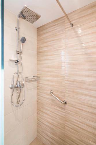 a shower with a glass door in a bathroom at Castelia Luxury Villas in Agios Ioannis