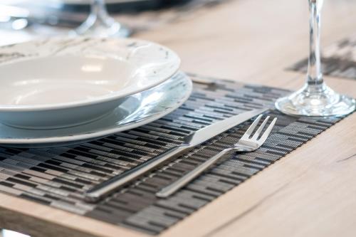 a table with a plate and a fork and knife at Castelia Luxury Villas in Agios Ioannis