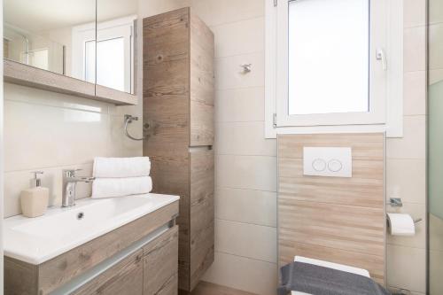 a bathroom with a sink and a mirror at Castelia Luxury Villas in Agios Ioannis