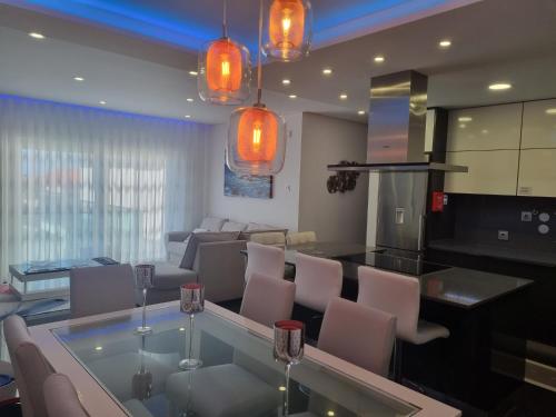 a kitchen and living room with a glass table and chairs at My 2and house in Baleal