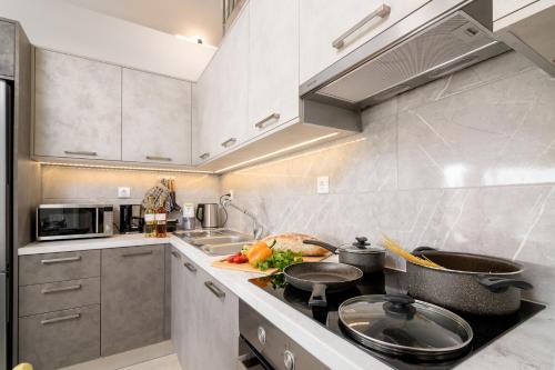 a kitchen with a sink and a stove top oven at Castelia Luxury Villas in Agios Ioannis
