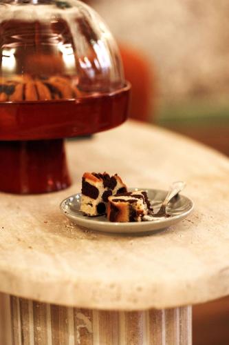 a piece of cake on a plate on a table at Hotel de Fleurie - Saint-Germain-des-Pres in Paris