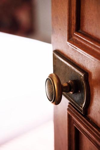 a wooden door with a brass door knob at Hotel de Fleurie - Saint-Germain-des-Pres in Paris