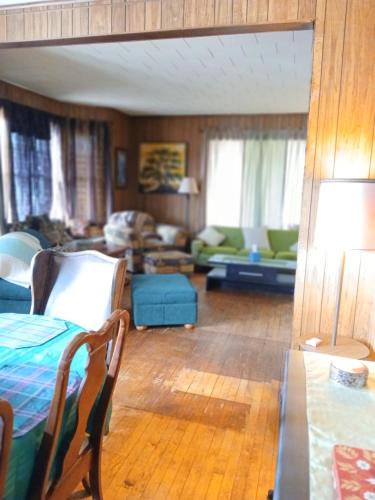 a living room with a bed and a couch at Hemlock House in Ironwood