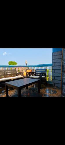 a view of tables and benches on a balcony at CIDMAT VILLA in Freetown