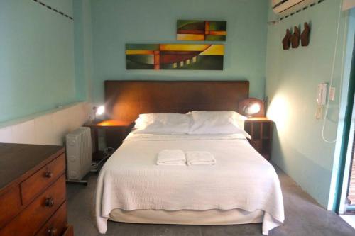 a bedroom with a bed with two towels on it at CasaSanTelmo 2984 in Buenos Aires