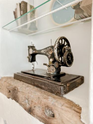 an old sewing machine sitting on a piece of wood at Mountain Bliss Guesthouse 2 next to Sougia in Agrilés