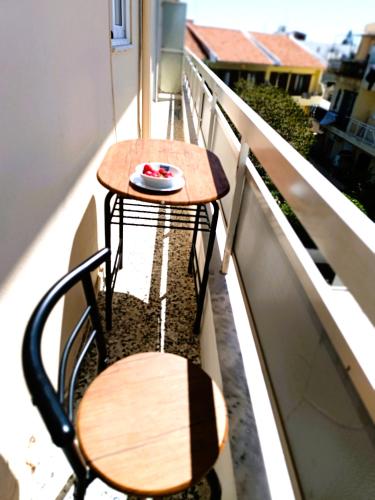 a table and bench on the balcony of a balcony at Nautilus City Studios & Apartments in Rhodes Town