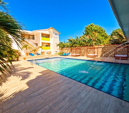a swimming pool in front of a house at Hotel Caribbean Coral in San Andrés