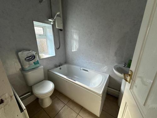 a bathroom with a tub and a toilet and a sink at King House in Carlisle