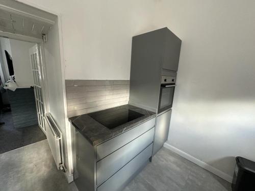 a kitchen with a refrigerator and a counter top at King House in Carlisle