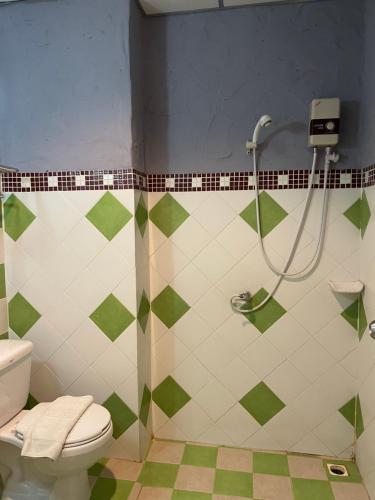 a bathroom with a shower and a toilet at Retro guesthouse in Pattaya South