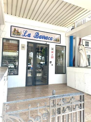 a building with a bench in front of a store at Barraca Suites in Valencia