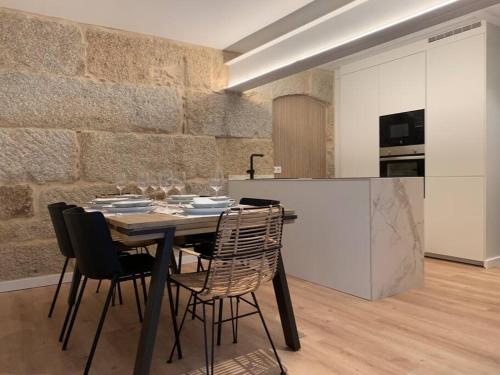 uma sala de jantar com uma mesa e cadeiras numa cozinha em LAS TERRAZAS I em Ourense