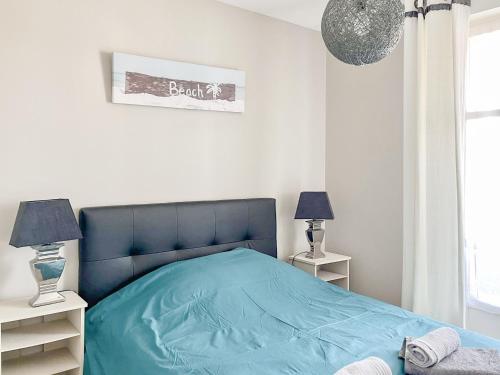 - une chambre avec un lit bleu et 2 tables de chevet dans l'établissement Spacieux appartement quartier de La Chaume - 4 pers, à Les Sables-dʼOlonne