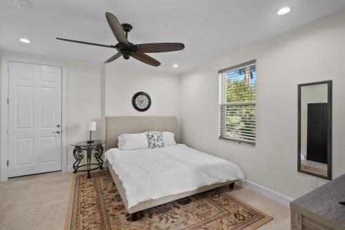 a bedroom with a bed and a ceiling fan at 2/1 Riverside Retreat with Loft in Fort Pierce