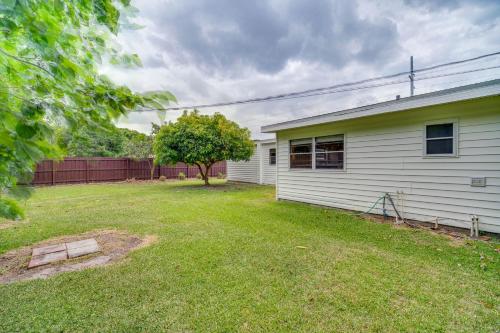 an empty yard next to a white house at Vero Beach Vacation Rental about 3 Mi to the Ocean! in Vero Beach