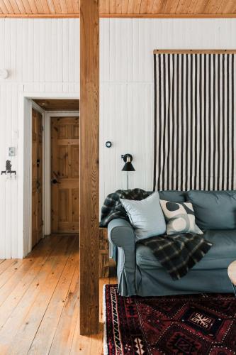 a living room with a couch with pillows on it at Alpine Lake House - Waterfront on Lake Muskoka in Port Carling