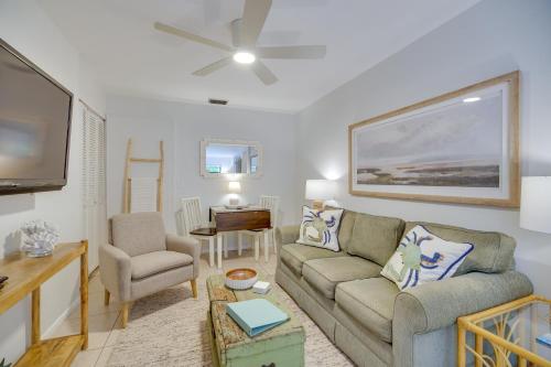 a living room with a couch and a tv at Vero Beach Studio with Shared Patio about 3 Mi to Beach! in Vero Beach