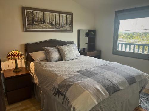 a bed in a bedroom with a window and a bed sidx sidx sidx at Mountainside Cabin in Newcastle