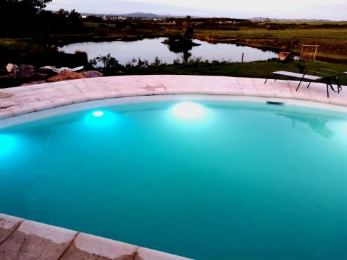 a swimming pool with a view of a lake at Casas del lago in Pan de Azúcar