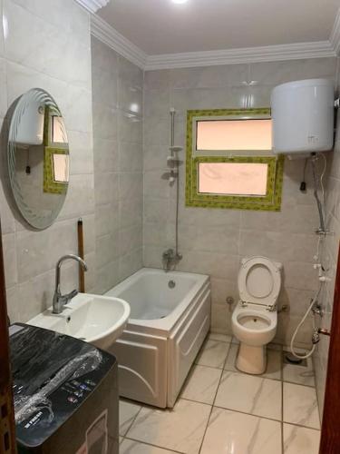La salle de bains est pourvue d'une baignoire, de toilettes et d'un lavabo. dans l'établissement Nile View Cozy Appartment, au Caire