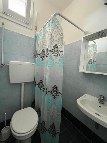 a bathroom with a toilet and a sink at Vista Mare in Torre San Gennaro
