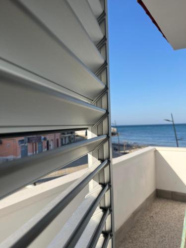 a view of the ocean from the balcony of a house at Vista Mare in Torre San Gennaro