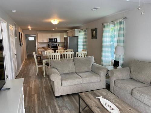 a living room with two couches and a kitchen at Surfside Beach/ Capt. Jacks ~50 FT From Beach 3br/3ba in Myrtle Beach