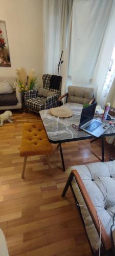 a living room with a table with a laptop on it at Alsancak seaside 50 m Single room green in Konak