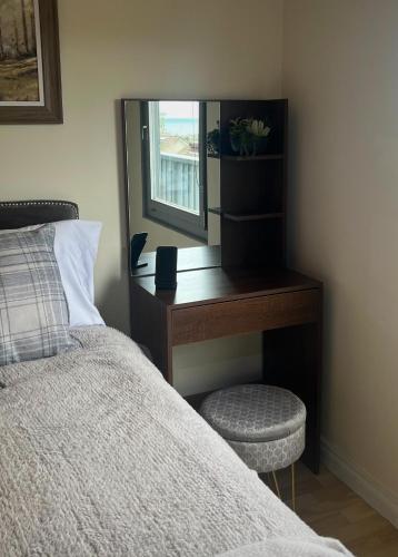 a bedroom with a desk with a bed and a chair at Mountainside Cabin in Newcastle