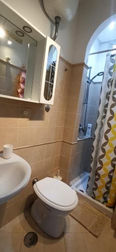 a bathroom with a toilet and a sink and a mirror at Villa dei fiori B&B in Capri