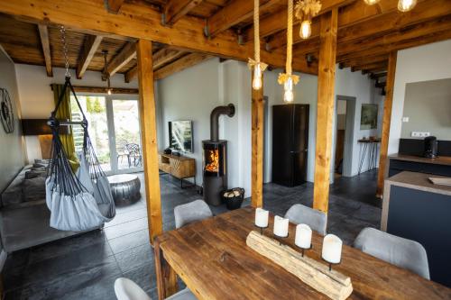 a living room with a wooden table and a fireplace at SAUERLAND CHALETS - "Die Chalets am Bergelchen" in Winterberg